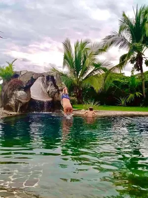 a person in the water in a swimming pool at Casa Vista Pacifico in Esterillos