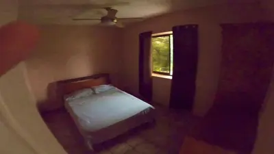 a small bedroom with a bed and a window at Casa Vista Pacifico in Esterillos