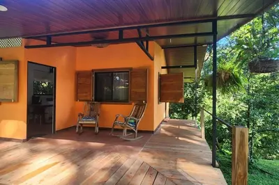 a porch of a house with two chairs at Hermosa cabaña con espacios al Aire Libre! in San Francisco