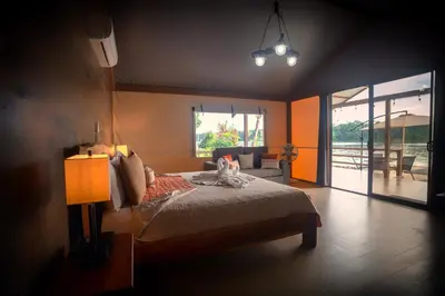 a bedroom with a bed with a cat sitting on it at Valverde Glamping & Ecolodge in Tortuguero