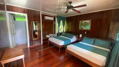 a bedroom with two beds and a ceiling fan at Valverde Glamping & Ecolodge in Tortuguero