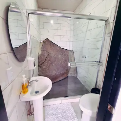 a bathroom with a shower and a sink at La Piedra in Alajuela City