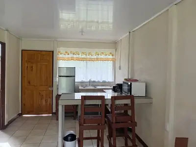 a kitchen with a table and chairs and a sink at Apartamentos ecológicos in Jiménez