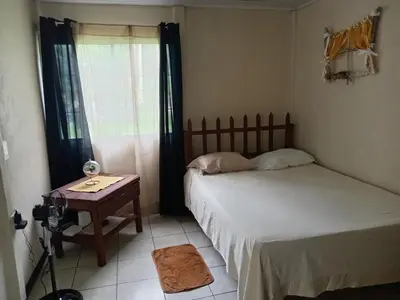 a bedroom with two beds and a table and a window at Apartamentos ecológicos in Jiménez