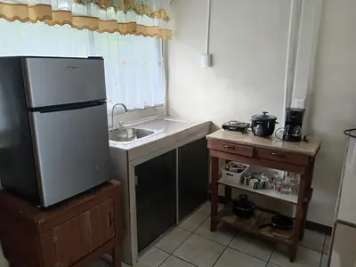 a small kitchen with a sink and a refrigerator at Apartamentos ecológicos in Jiménez