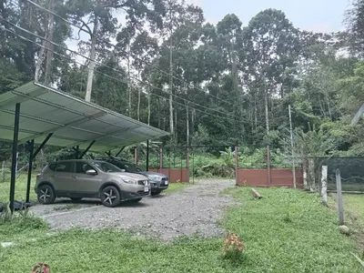 a car parked under a canopy in a driveway at Apartamentos ecológicos in Jiménez