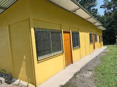 a yellow building with orange doors on it at Apartamentos ecológicos in Jiménez