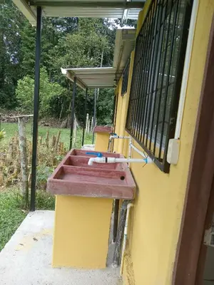 a sink on the side of a house at Apartamentos ecológicos in Jiménez