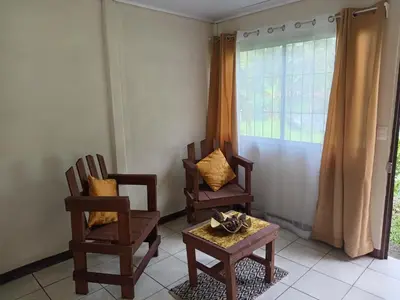 two chairs and a table in a room with a window at Apartamentos ecológicos in Jiménez