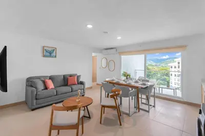 a living room with a couch and a table at Upstay - 3BR New Condo in Jaco 5mins to Beach in Jacó