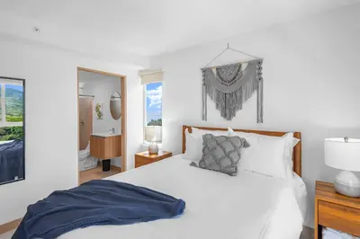 a white bedroom with a bed and a mirror at Upstay - 3BR New Condo in Jaco 5mins to Beach in Jacó