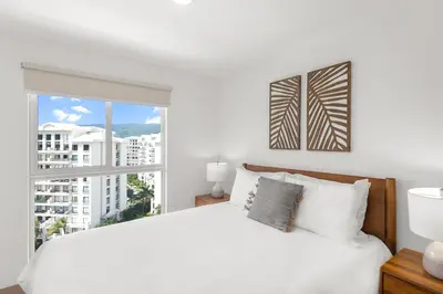 a bedroom with a white bed and a large window at Upstay - 3BR New Condo in Jaco 5mins to Beach in Jacó
