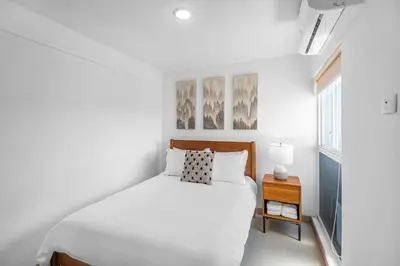 a white bedroom with a bed and a window at Upstay - 3BR New Condo in Jaco 5mins to Beach in Jacó