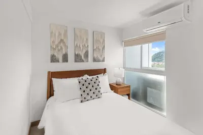 a white bedroom with a bed and a window at Upstay - 3BR New Condo in Jaco 5mins to Beach in Jacó