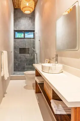 a bathroom with a sink and a toilet and a mirror at Coco Nosara Villas Guiones Family Resort Casa José in Nicoya