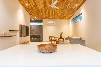 a kitchen and living room with a ceiling fan at Coco Nosara Villas Guiones Family Resort Casa José in Nicoya