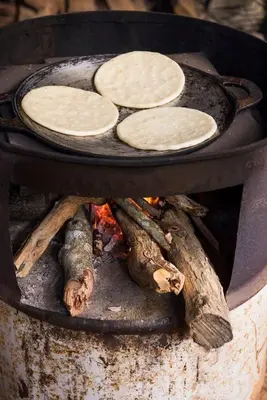 a bunch of food cooking in a pan on a stove at Finca Anjala - Architectural lodge on sustainable in Ojochal