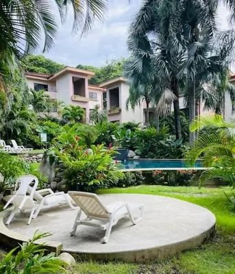 a group of chairs sitting on a patio in front of a house at Casa de Romá in Coco