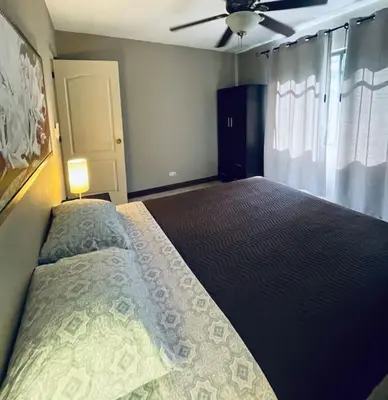 a bedroom with a large bed and a ceiling fan at Casa de Romá in Coco