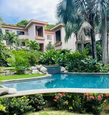 a resort with a swimming pool in front of a building at Casa de Romá in Coco