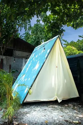 a tent sitting on the ground under a tree at Argdivan Beach Hostel in Sámara