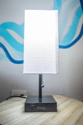 a lamp sitting on top of a wooden table at Argdivan Beach Hostel in Sámara