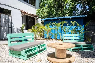 two chairs and a table and a table and a bench at Argdivan Beach Hostel in Sámara