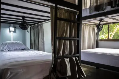 a bedroom with two bunk beds and a window at Argdivan Beach Hostel in Sámara