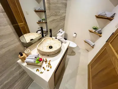 a bathroom with a sink and a mirror at House 15 min from the beach with river access in Ojochal