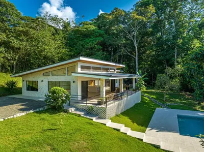 a house with a swimming pool in front of it at House 15 min from the beach with river access in Ojochal