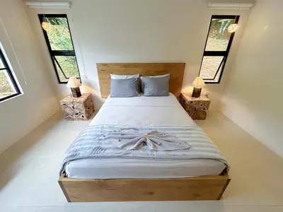 a bedroom with a bed with a dress on it at House 15 min from the beach with river access in Ojochal
