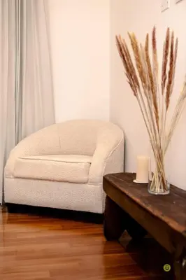 a living room with a chair and a wooden table at Comfort and style in San José
