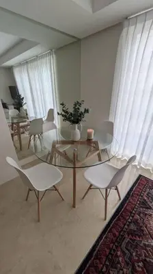 a living room with a glass table and chairs at Comfort and style in San José
