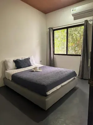 a bedroom with a bed and a window at Koba Village Santa Teresa in Santa Teresa Beach