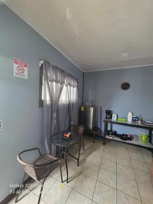 a living room with a table and chairs at HOUSE Of Rainbow in Tortuguero