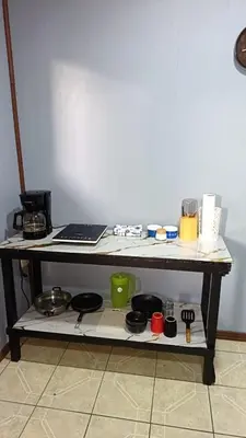 a table with pots and pans on top of it at HOUSE Of Rainbow in Tortuguero