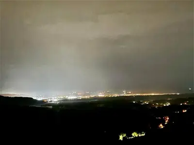 a view of a city at night with lights at Cabaña con piscina y vista al mar in Puntarenas