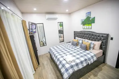a small bedroom with a bed and a couch at Villa Graceland - Arenal Volcano View in Fortuna