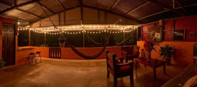 a room with a stage with chairs and lights at Hacienda el Paraíso in Guápiles