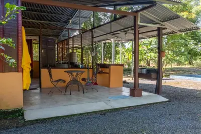 a pavilion with a table and chairs on a patio at Hacienda el Paraíso in Guápiles