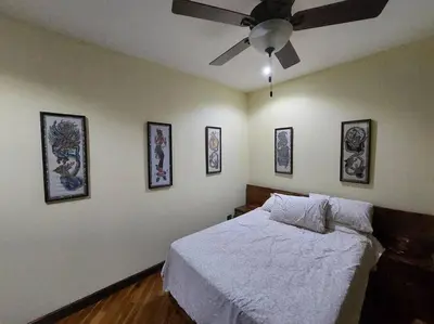 a bedroom with a bed and a ceiling fan at Beautiful 3BR Lakeshore House in Gated Community in Tilarán