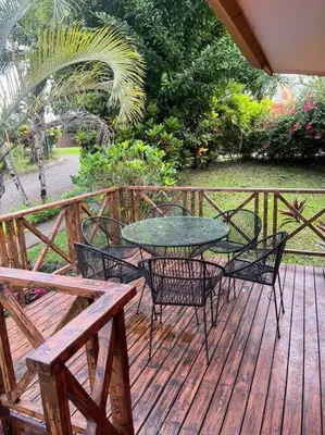 a patio with a table and chairs on a deck at Beautiful 3BR Lakeshore House in Gated Community in Tilarán