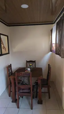 a dining room table with two chairs and a wooden table and chairs at White Passiflora - Private Jacuzzi in Fortuna