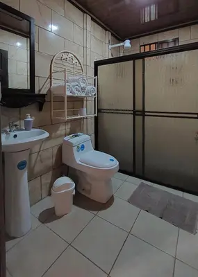 a bathroom with a toilet and a sink at White Passiflora - Private Jacuzzi in Fortuna