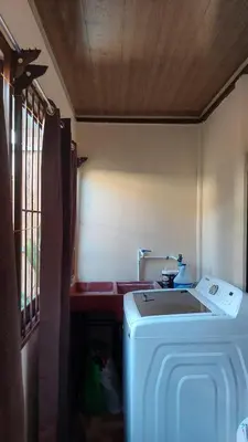 a kitchen with a washing machine in a room at White Passiflora - Private Jacuzzi in Fortuna