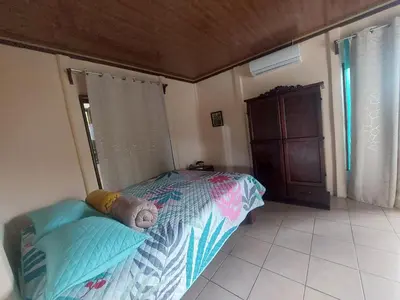 a bedroom with a bed with a teddy bear on it at White Passiflora - Private Jacuzzi in Fortuna