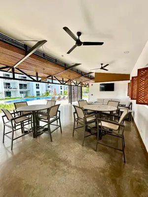 a dining room with tables and chairs and a ceiling fan at Viva in Jacó