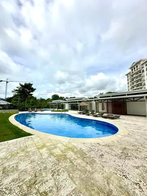a swimming pool in the yard of a building at Viva in Jacó