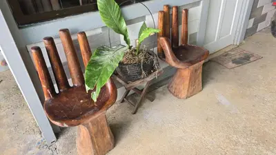 a group of wooden utensils sitting next to a door at Happy Paradise Lodge in Nuevo Arenal
