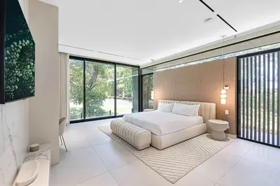 a bedroom with a white bed and large windows at Luxurious Villa in Papagayo in Nacascolo
